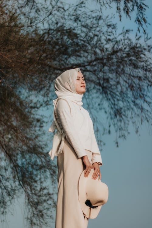 Free Woman in White Hijab Standing Near Trees Stock Photo