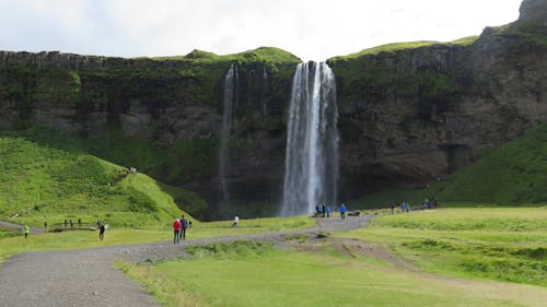 Tourist Enjoying the Beautiful Waterfalls Scenery