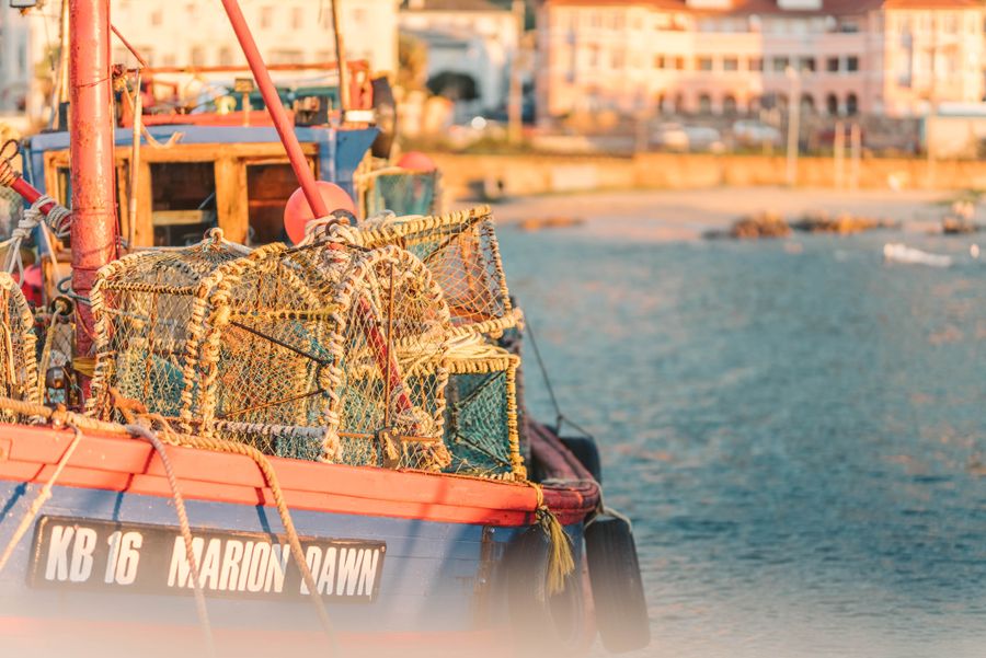 Lobster pots stacked aboard a working fishing boat