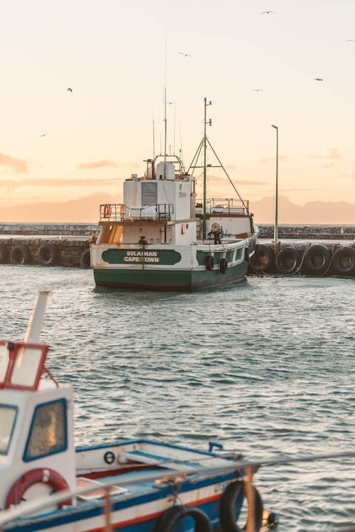 Green and White Boat on Dock