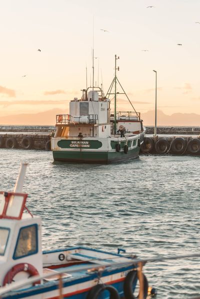 Fishing boat leaving the harbour at dawn — Taryn Elliott on Pexels