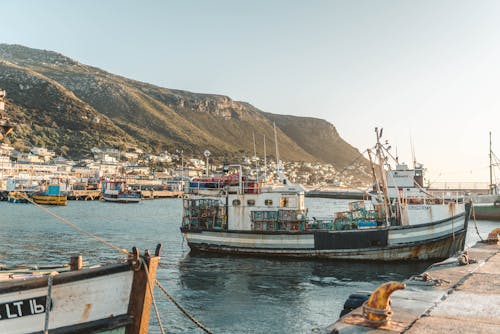 Free White and Blue Boat on Water Near Mountain Stock Photo