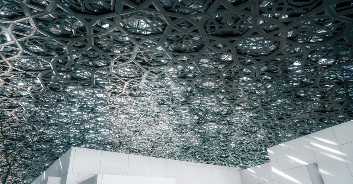 Intricate ceiling design at the Louvre Abu Dhabi showcasing modern architecture.
