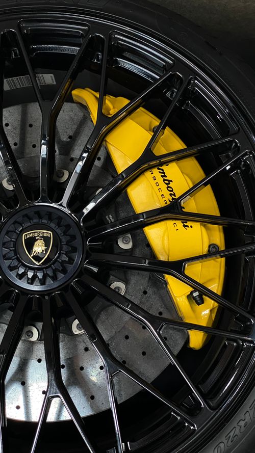 Free Close-up of a Lamborghini wheel showcasing black rim and yellow brake caliper. Stock Photo