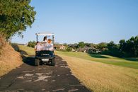 Black and White Golf Cart on Green Grass Field