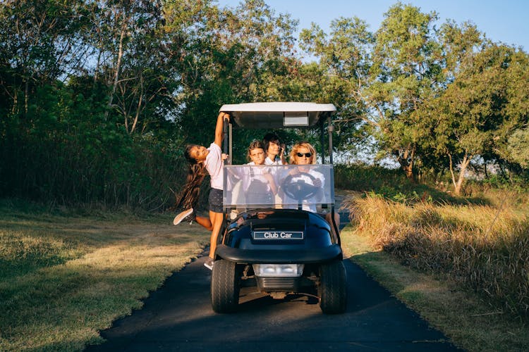 People Riding A Golf Cart