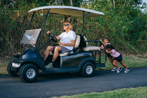 Girls Pushing a Golf Cart