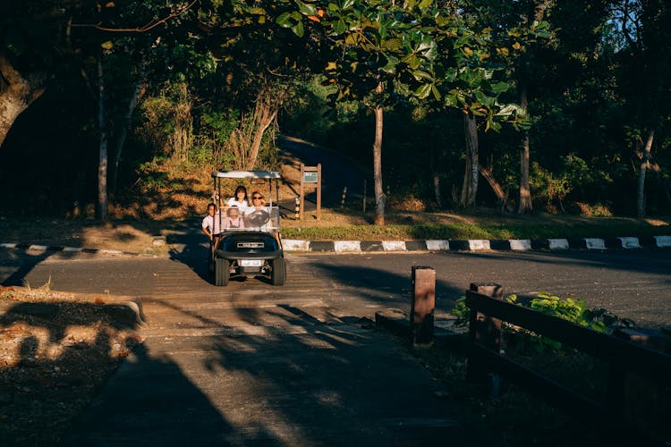 
A Family Riding A Golf Cart