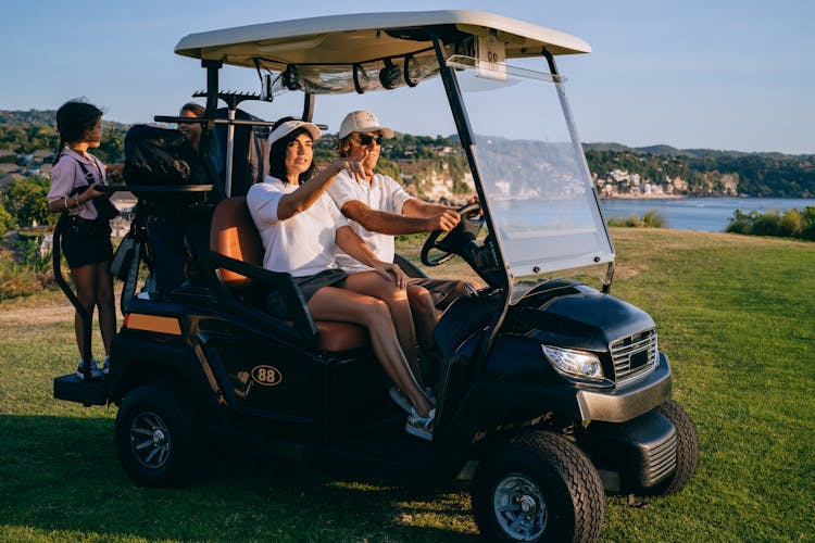 
A Family Riding A Golf Cart