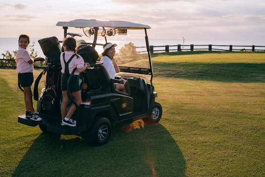 Cheerful family with children riding a golf cart outdoors during a scenic sunset at a golf course.