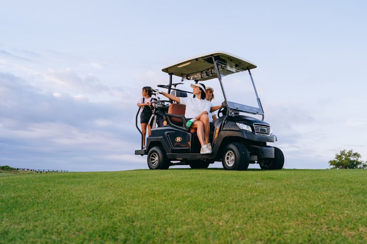 
A Family Riding A Golf Cart