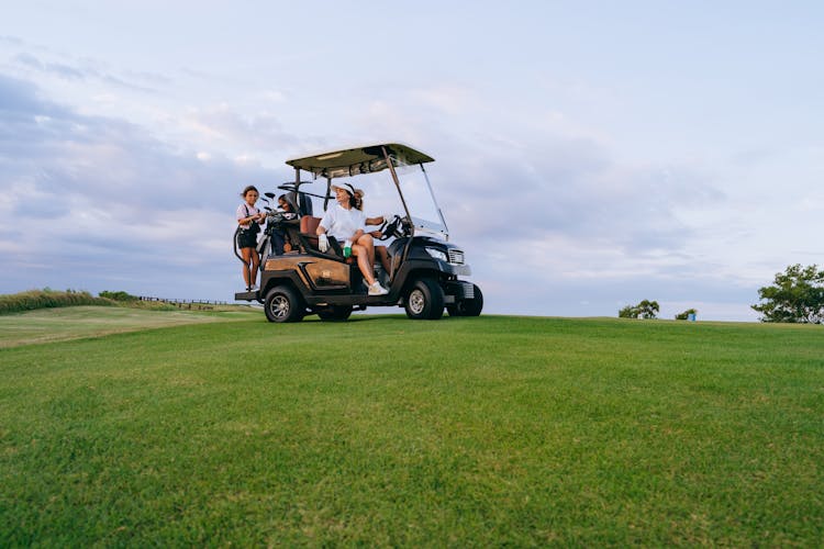 People Riding A Golf Cart