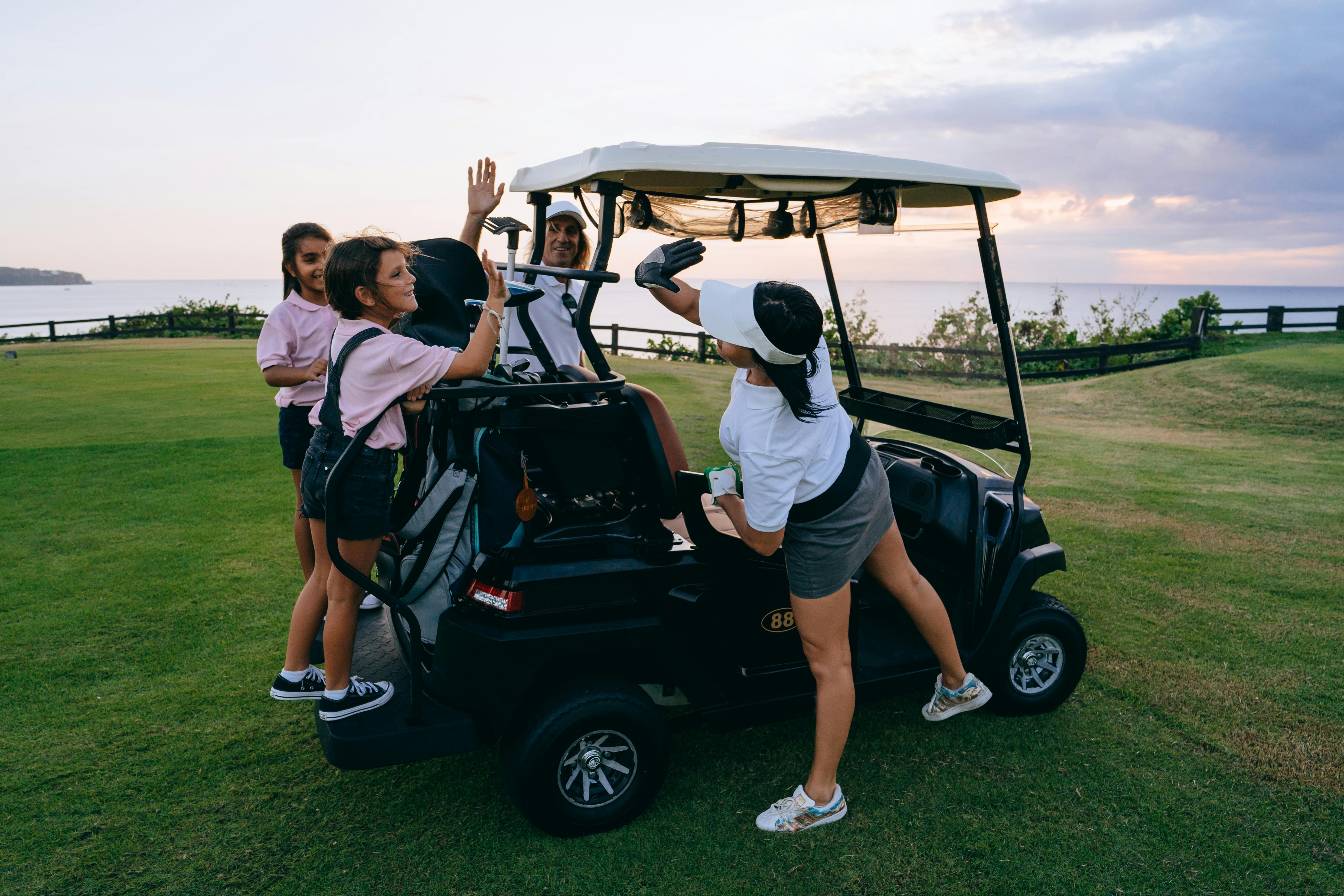 group of people riding on black golf cart