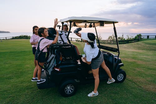 Group of People Riding on Black Golf Cart