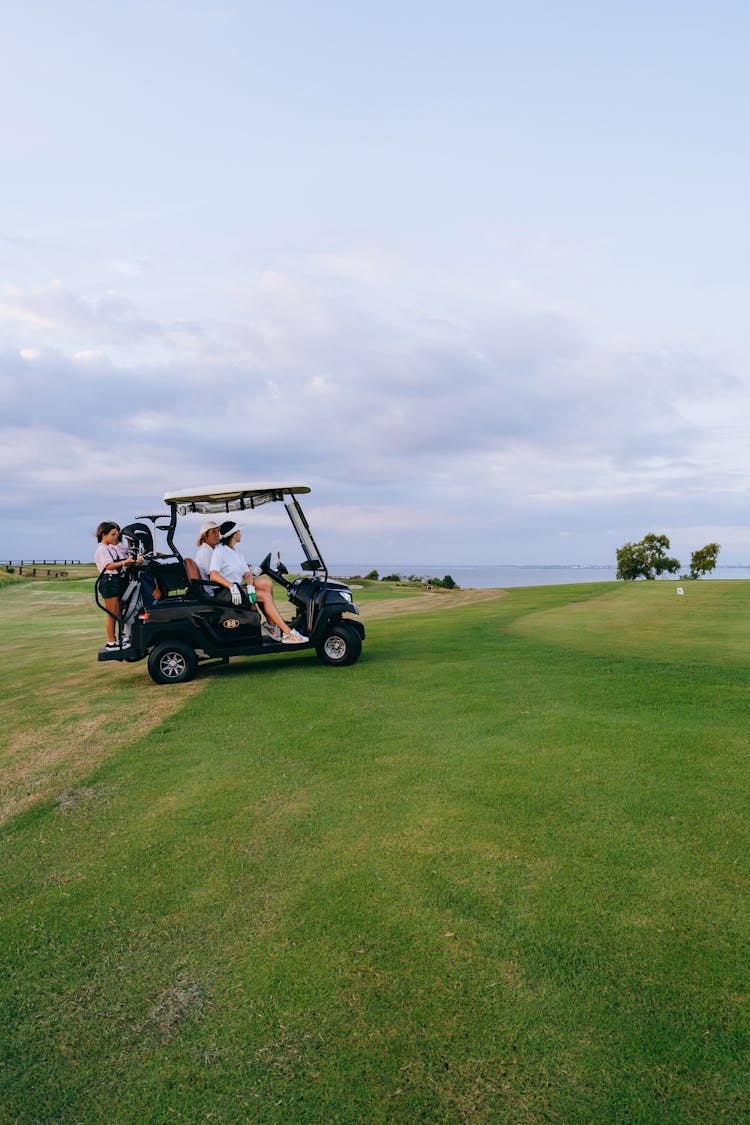 
A Family Riding A Golf Cart