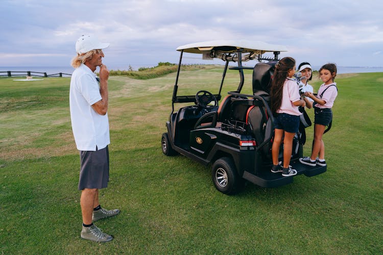 Family Spending Time On A Golf Course