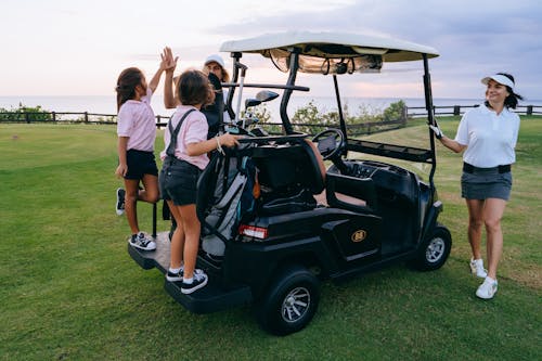 Smiling Women around Golf Cart
