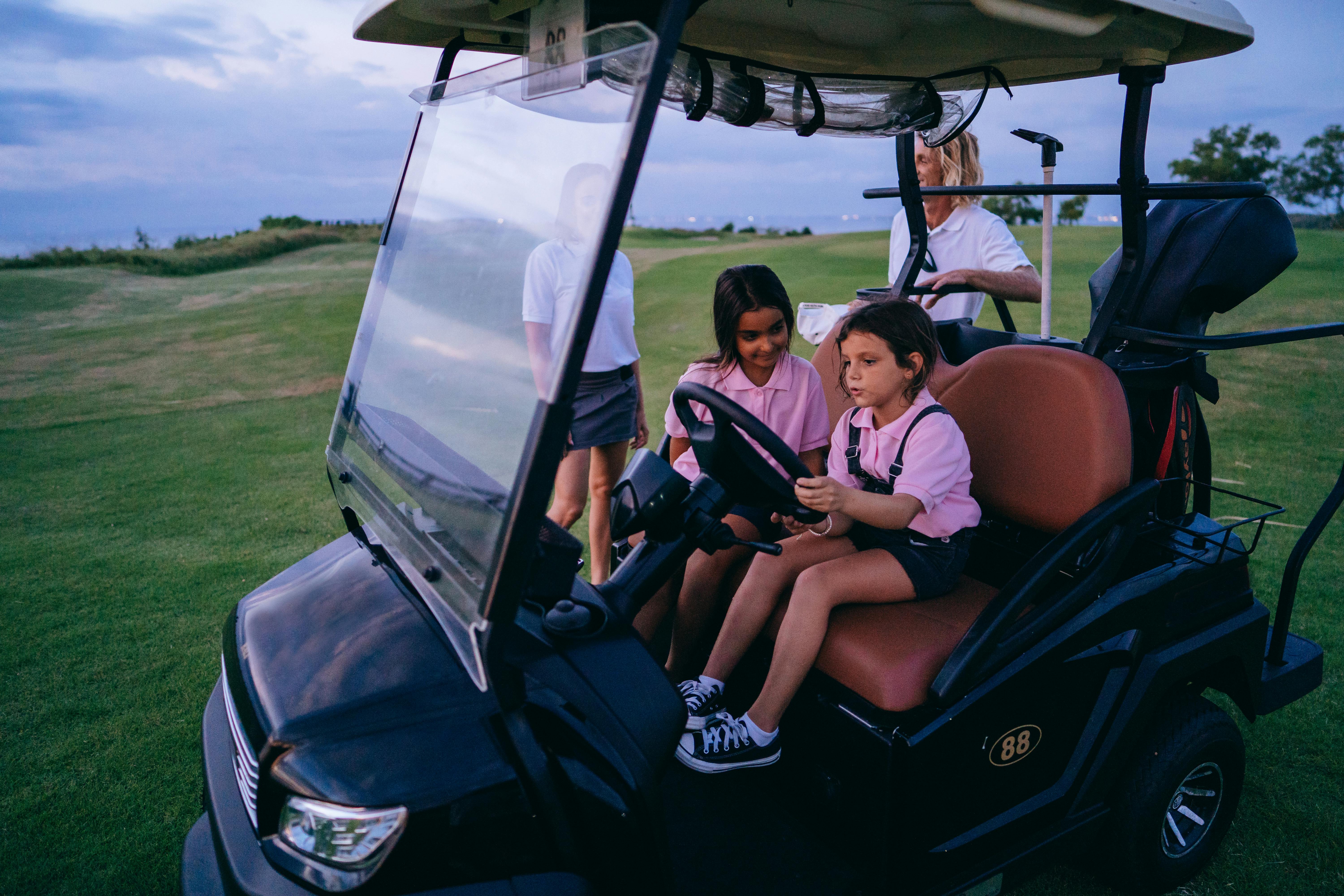 family spending time on a golf course