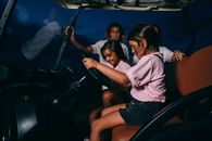 Woman in White Shirt Sitting on Black Car Seat