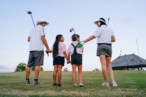 Free Happy family with children spending quality time playing golf together outdoors. Stock Photo