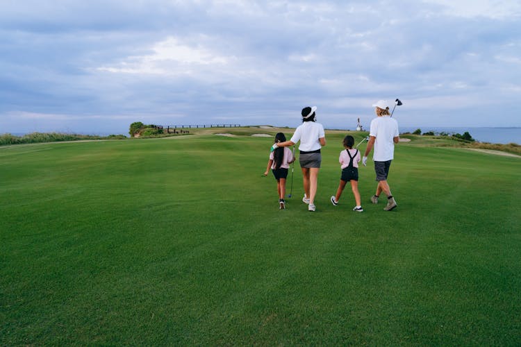 Family Walking On Golf Course