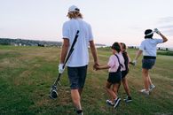 Man in White T-shirt and Black Shorts Holding Golf Club
