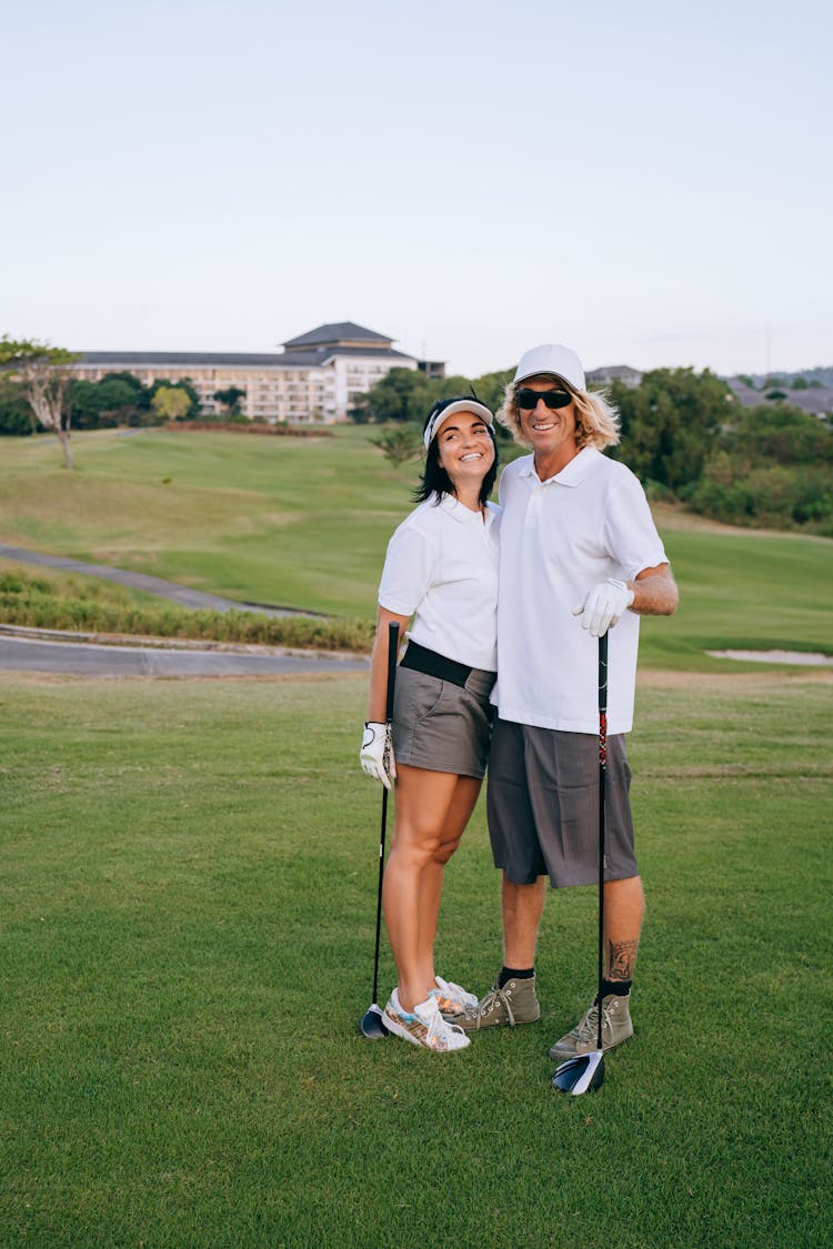 
A Couple Holding Golf Clubs