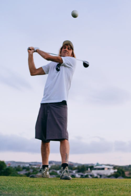 Free Man in White T-shirt playing Golf in Tilt-Shift Lens  Stock Photo