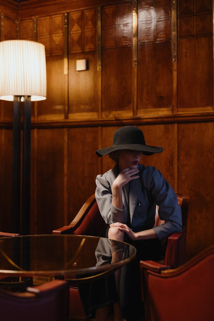 A Woman Wearing A Black Broad Brimmed Hat