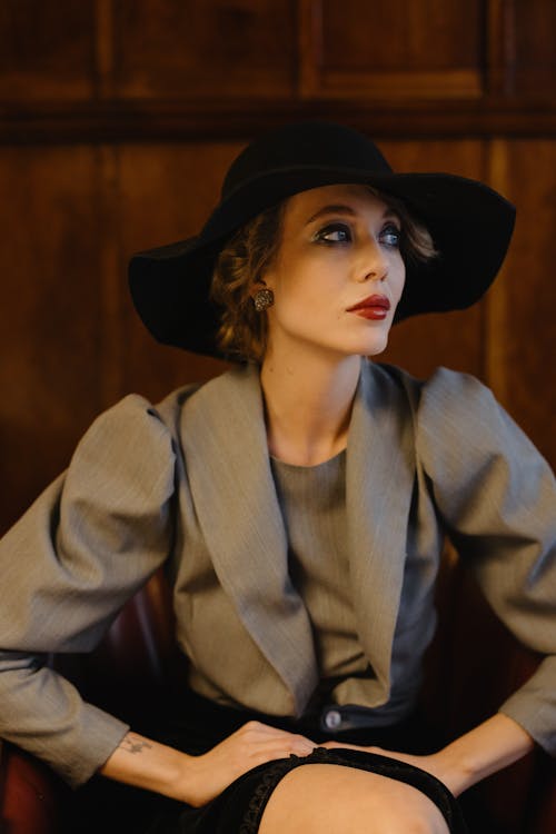 Elegant Woman in Gray Blazer and Black Hat