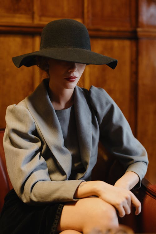 Elegant Woman in Gray Blazer and Black Hat