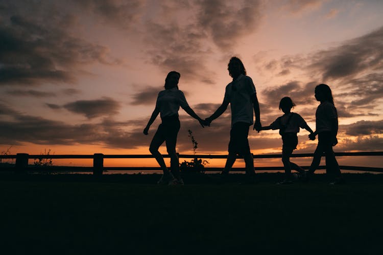 Silhouette Of Family Walking Together