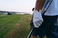 Person in White Long Sleeve Shirt Holding Black Stick