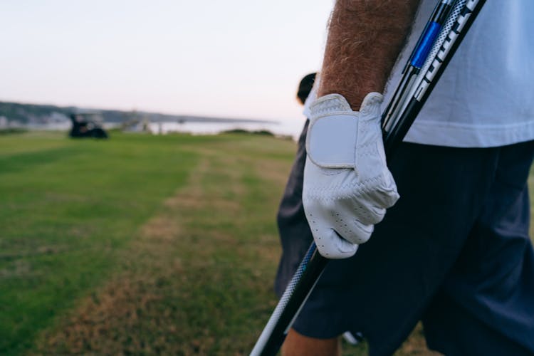 Close-Up Shot Of A Person Wearing White Golf Gloves