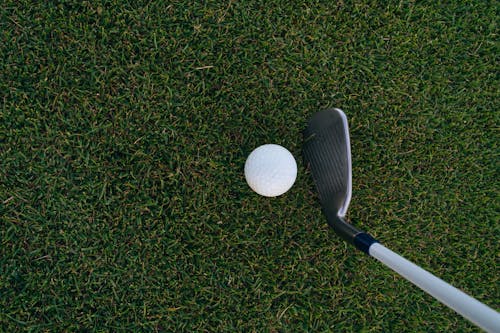 A Close-Up Shot of a Golf Ball and a Golf Club