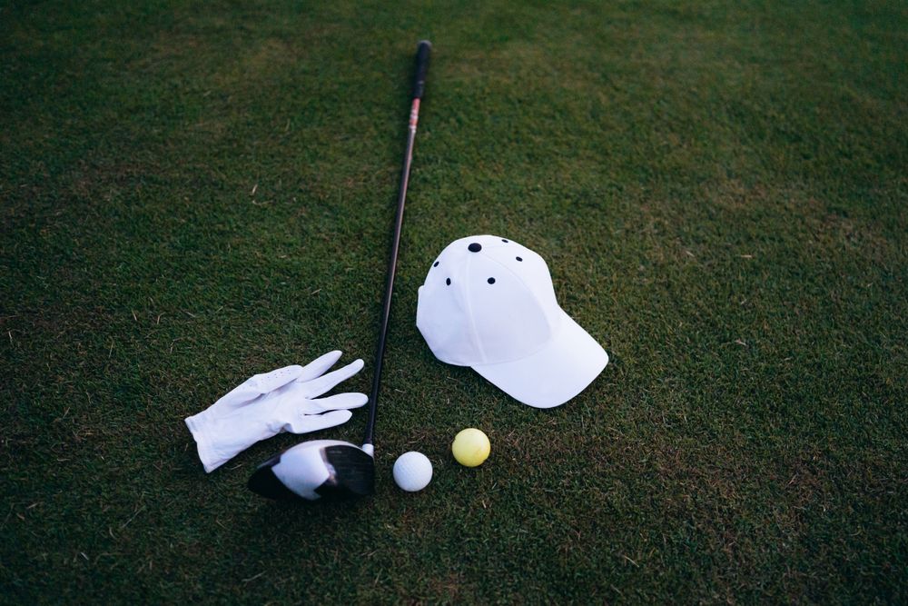 A leather headcover, a valuables pouch and a small engraved decanter arranged as a tournament gift set