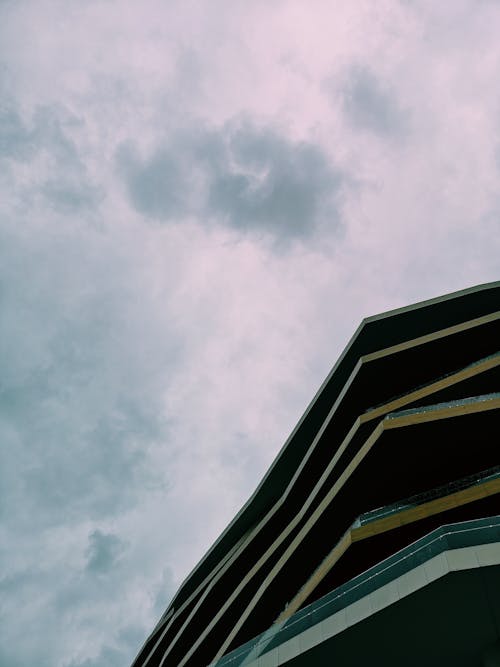 Low Angle Shot of Building under Cloudy Sky 
