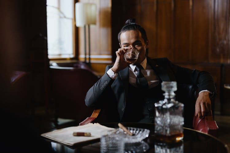 Man In A Black Suit Drinking Whiskey