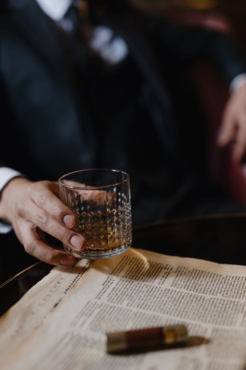 
A Person Holding a Glass of Whiskey