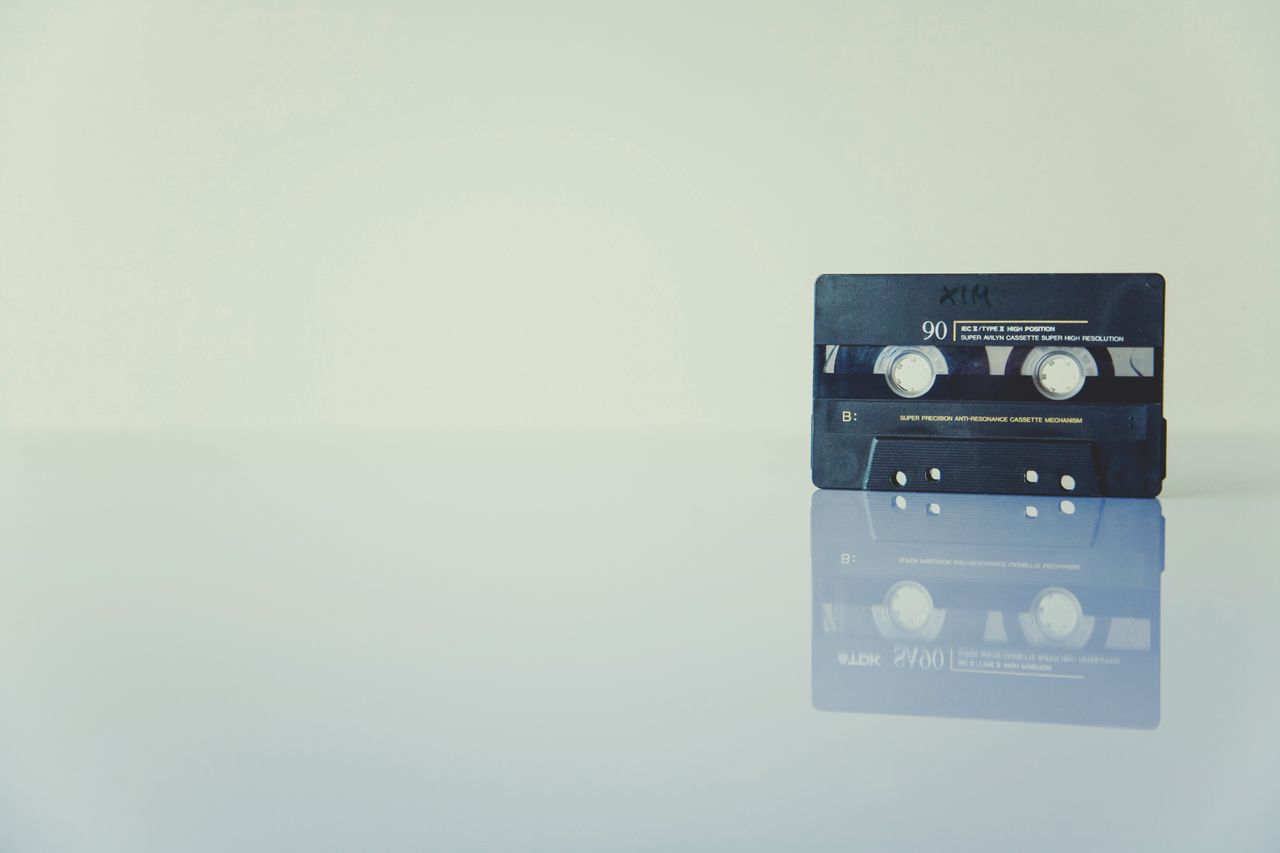 retro cassette tape on a reflective surface evoking nostalgia and vint