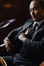 Man in Black Suit Jacket Holding White Tablet Computer