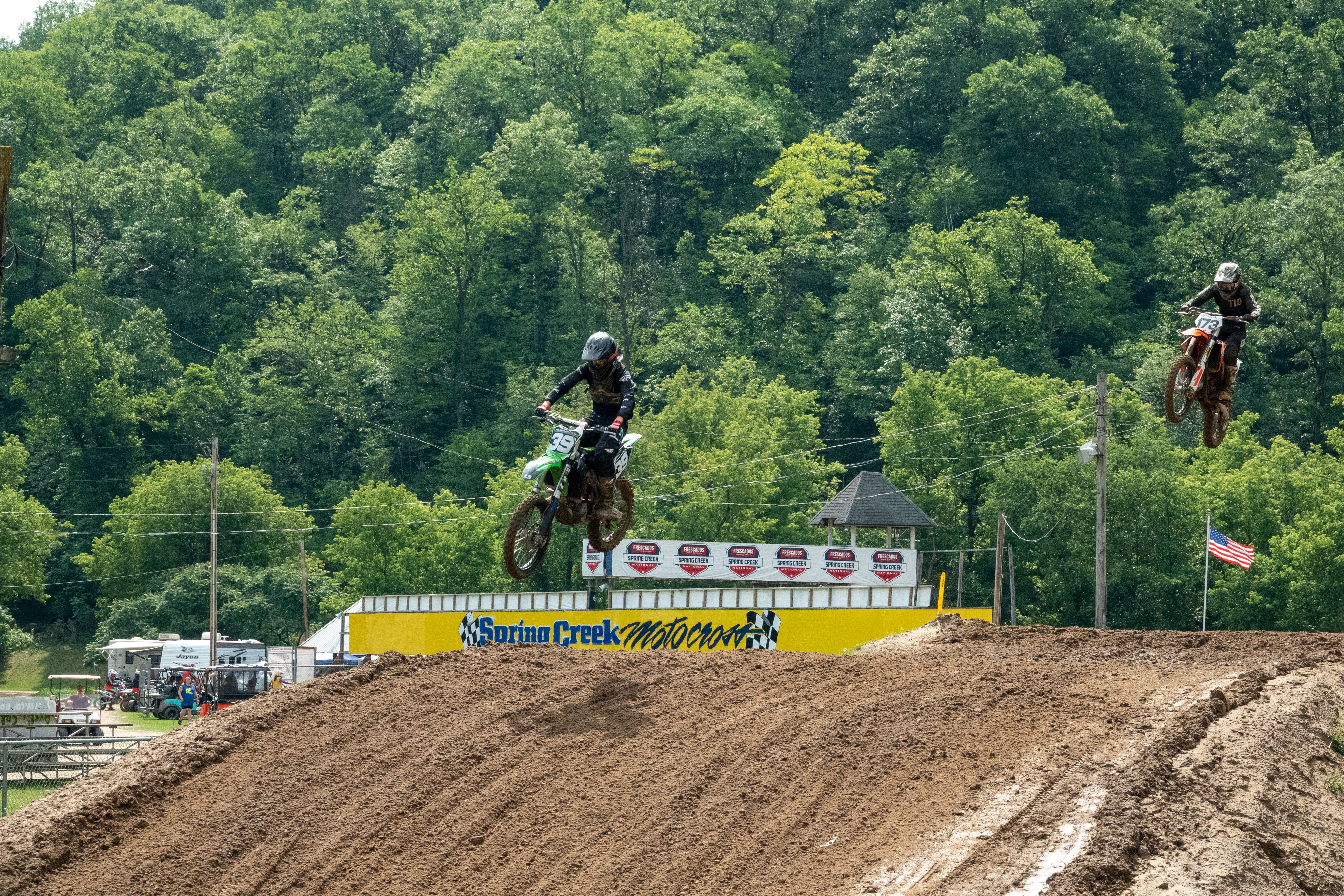 Thrilling motocross race at Spring Creek MX Park, Millville, featuring skilled riders and dirt bike stunts.