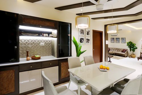 Free A sleek dining space featuring a modern table, stylish lighting, and elegant interior decor. Stock Photo