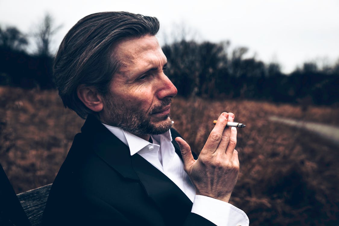 Photo of Man Holding a Cigarette