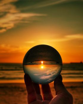 Stunning sunset beach view captured through a lensball, enhancing visual depth and vibrancy.