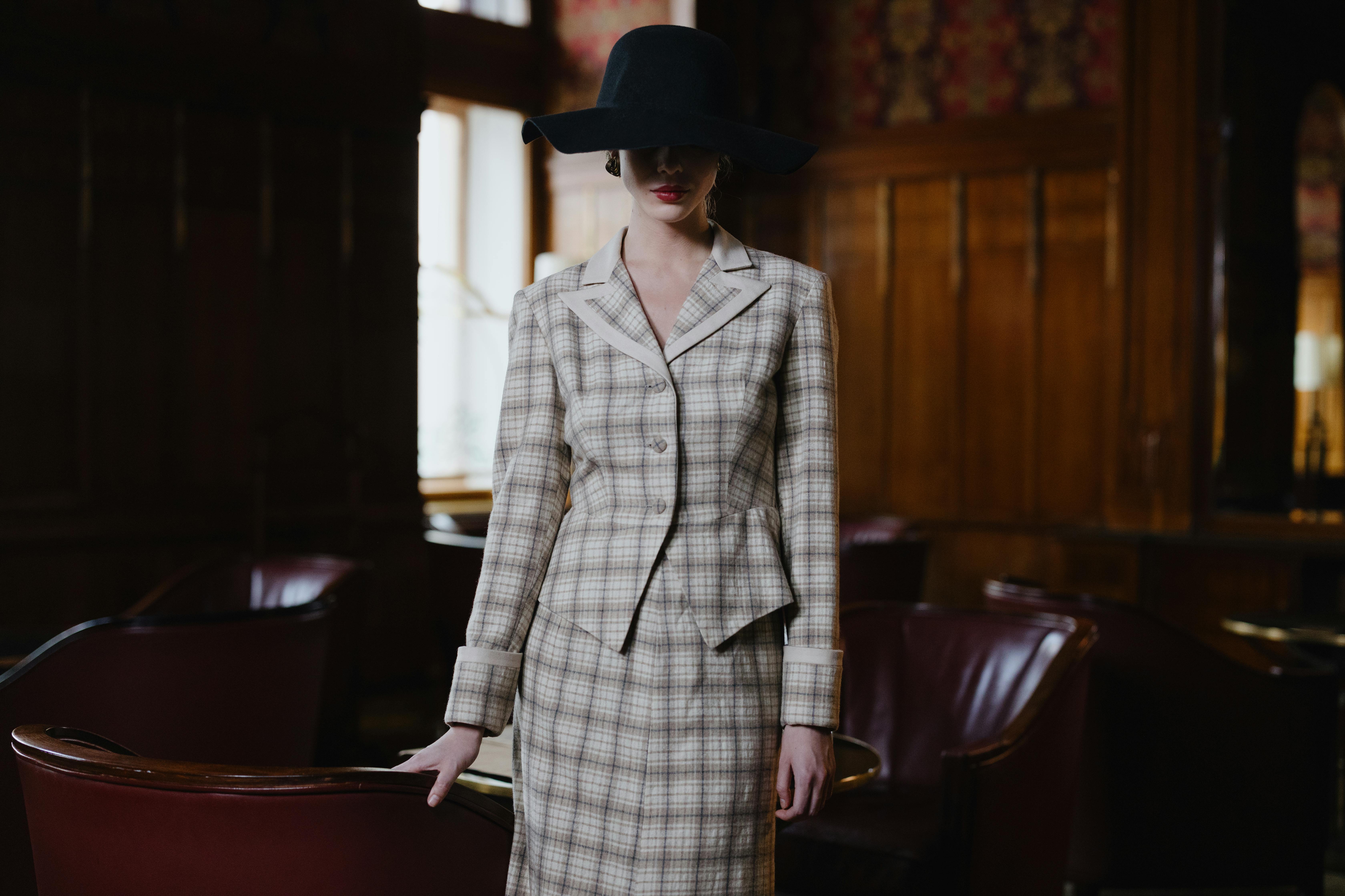 elegant woman in gray blazer and black hat