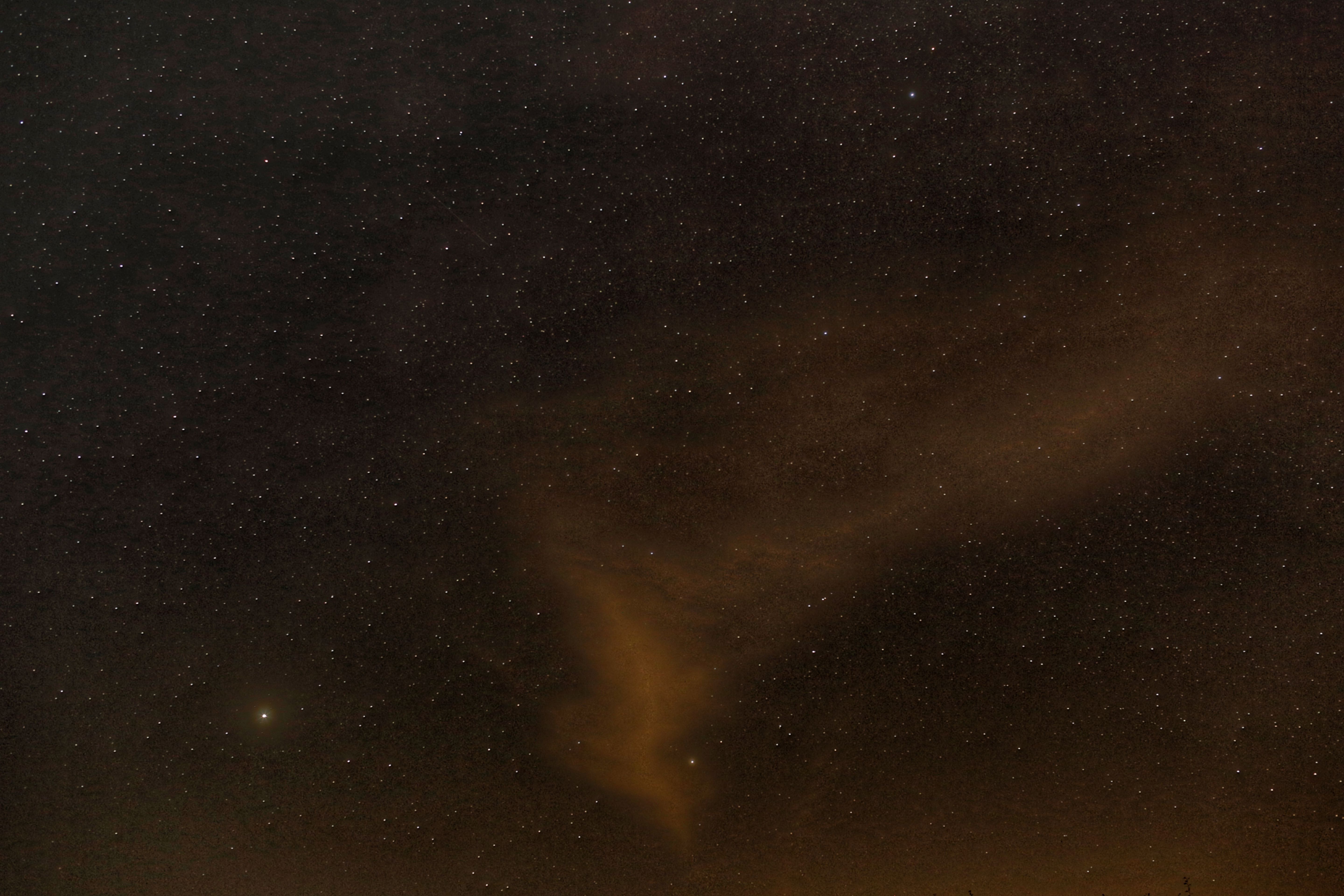 A mesmerizing view of a starry night sky with wispy clouds illuminated softly, perfect for backgrounds.