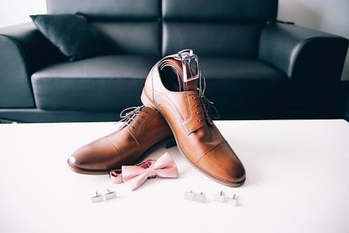 Free Brown Leather Lace Up Shoes on White Table Stock Photo