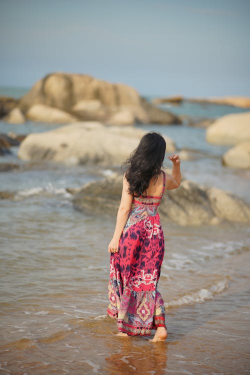 Back View of a Woman Walking at the Shore