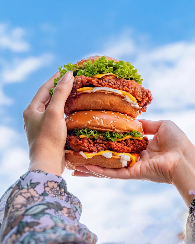 A Person Holding Chicken Sandwiches